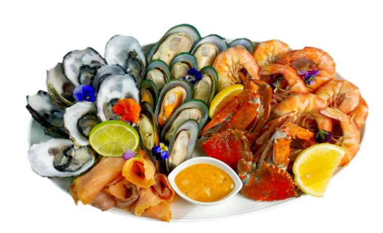 Assorted seafood platter with shrimp, mussels, and other items on a white background
