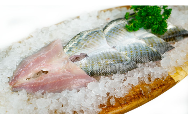 Tommy Ruff fillets on a bed of salt with a wooden board
