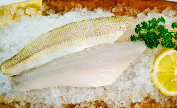 Yellow Fin fillets on a bed of salt with lemon and parsley garnish.